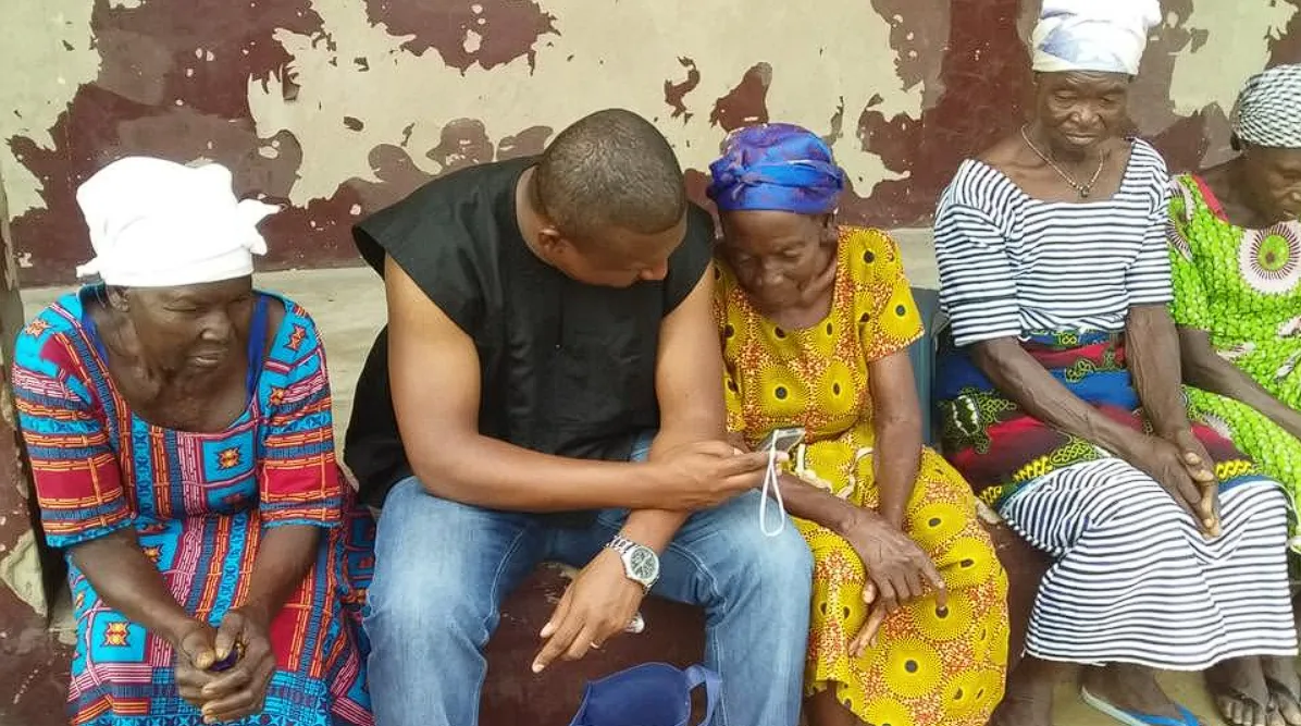 Two women seated together in conversation during a community visit